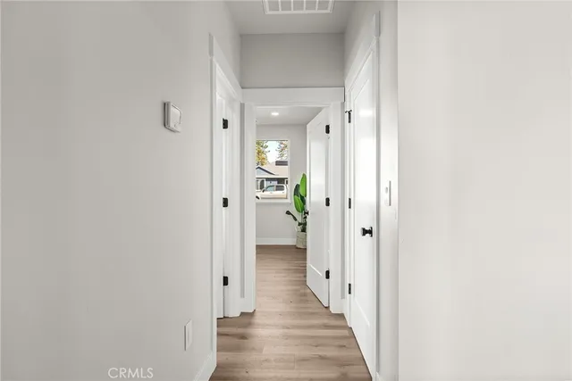a view of a hallway with wooden floor