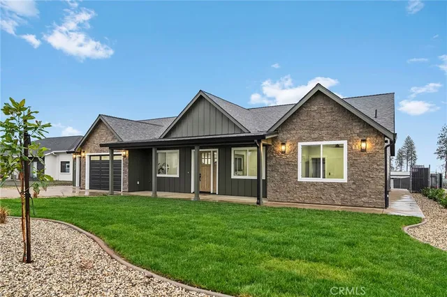 a front view of a house with a garden