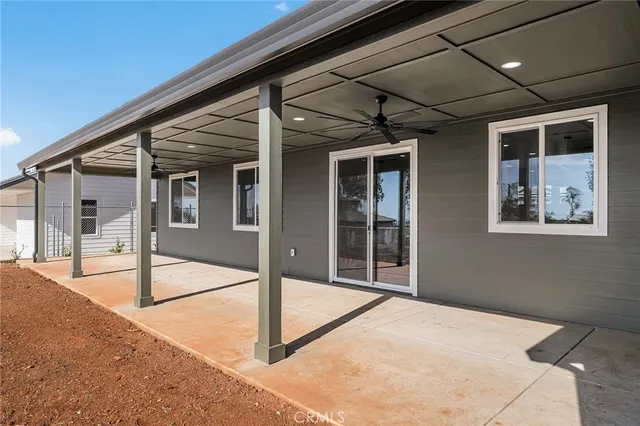 a view of dirt yard with large trees