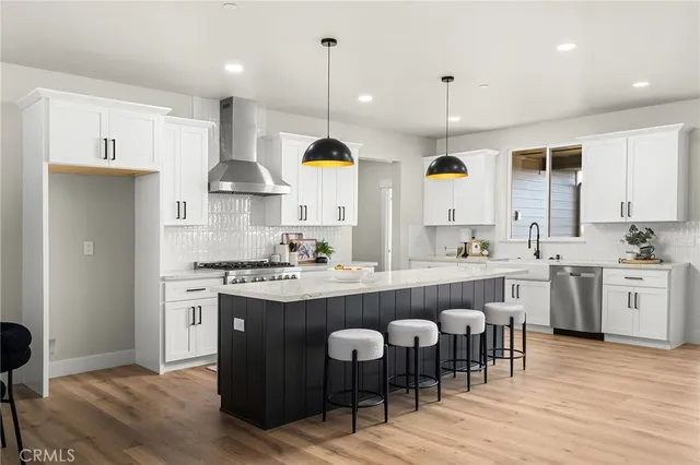 a large kitchen with a table and chairs in it