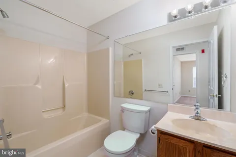 a bathroom with a sink toilet vanity and shower
