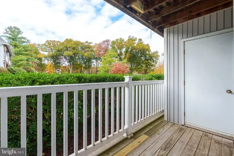 a view of a balcony with wooden floor