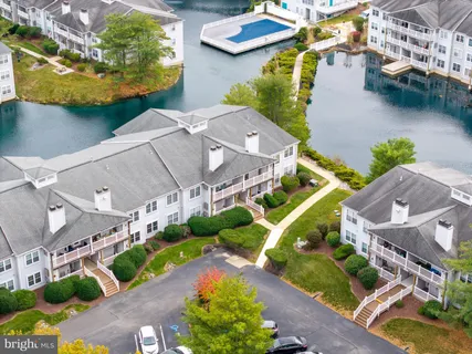 an aerial view of a house with a garden and lake view