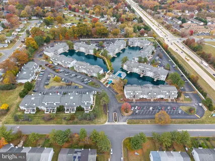 an aerial view of a house with swimming pool and outdoor seating