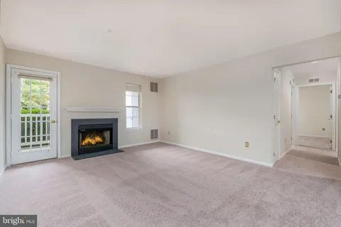 a view of an empty room with a fireplace