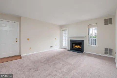 a view of an empty room with a fireplace
