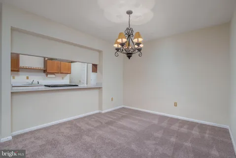 a view of a kitchen with stainless steel appliances granite countertop a sink and cabinets