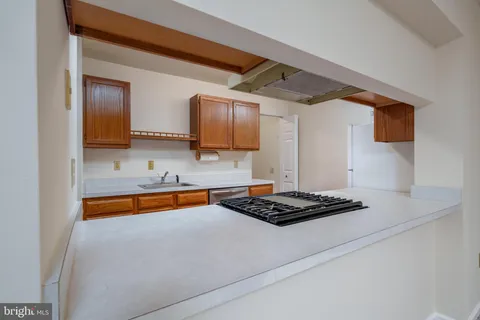 a kitchen with stainless steel appliances a sink and a stove