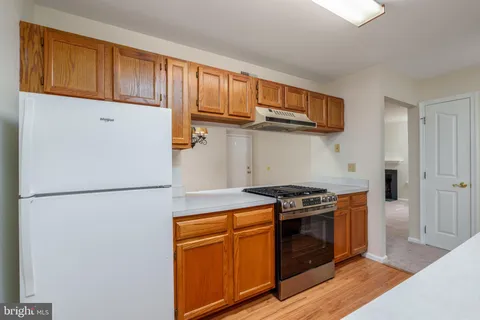 a kitchen with stainless steel appliances granite countertop a stove a refrigerator and a microwave