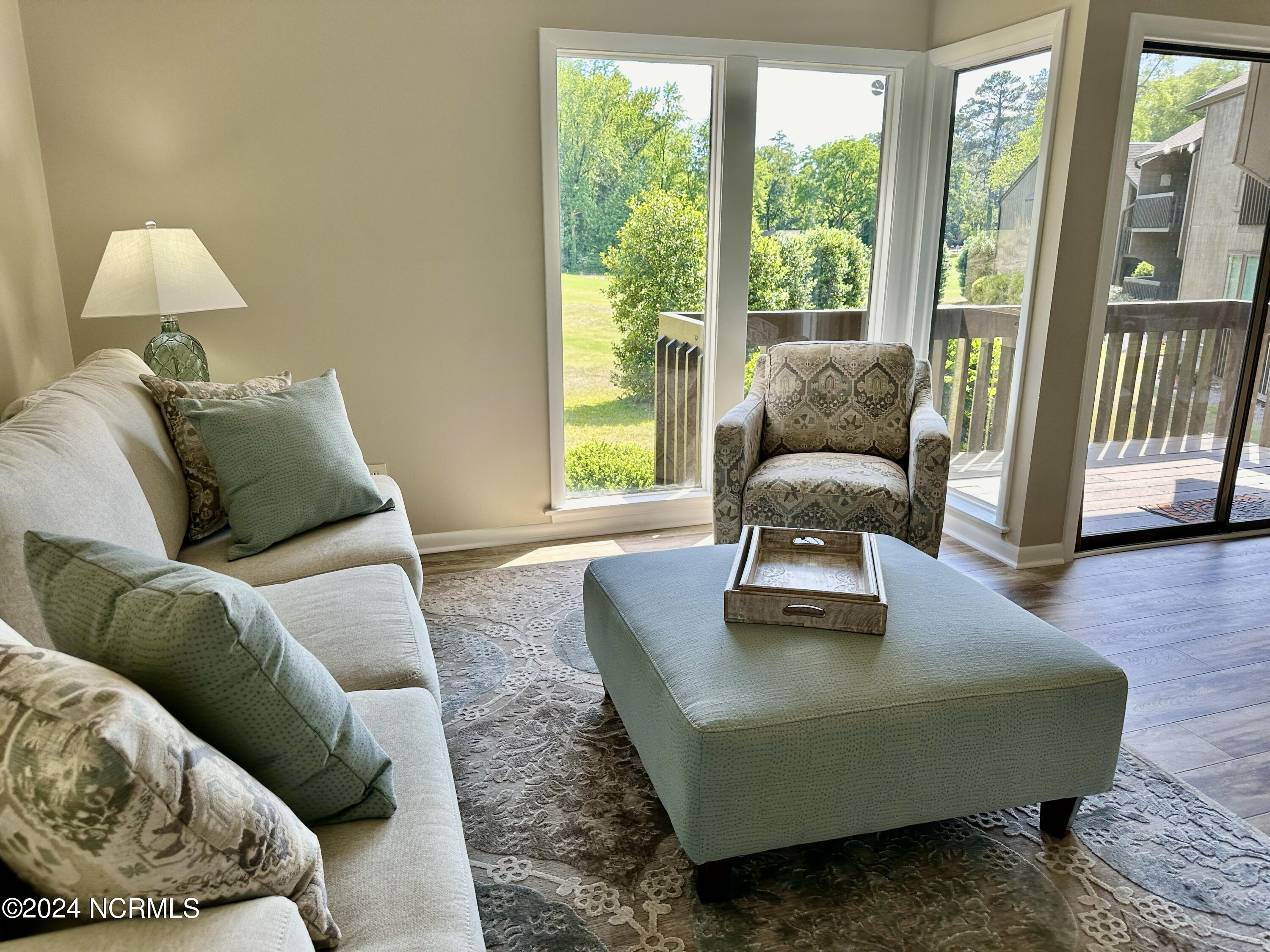 85 Pine Valley Road, Unit 29 Pinehurst, NC 28374 - Photo 6 of 36 Enjoy the comfy couch, swivel chair and ottoman