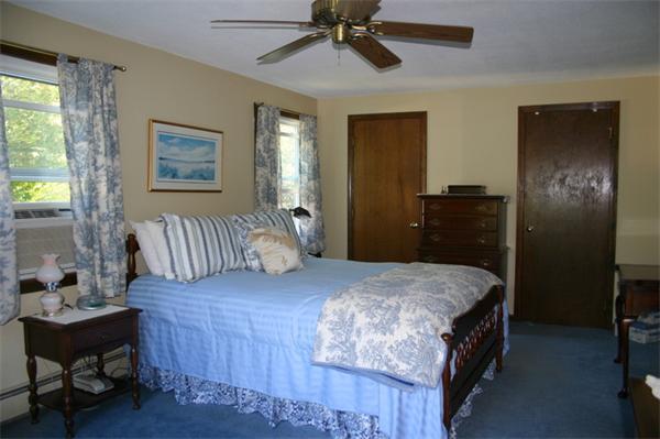 104 Laurel Road Wilbraham, MA 01095 - Photo 19 of 29 a bedroom with a bed and a chandelier