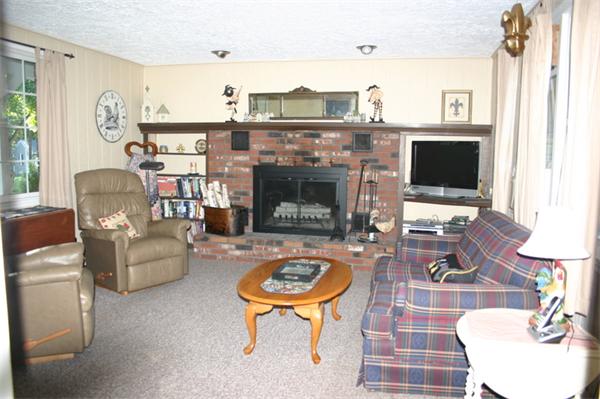 104 Laurel Road Wilbraham, MA 01095 - Photo 3 of 29 a living room with furniture a flat screen tv and a fireplace