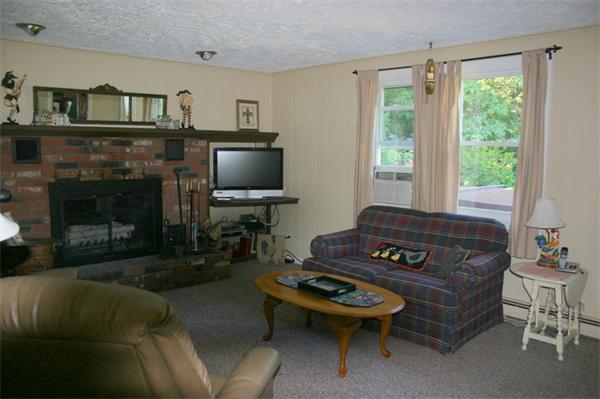 104 Laurel Road Wilbraham, MA 01095 - Photo 4 of 29 a living room with furniture a flat screen tv and a fireplace