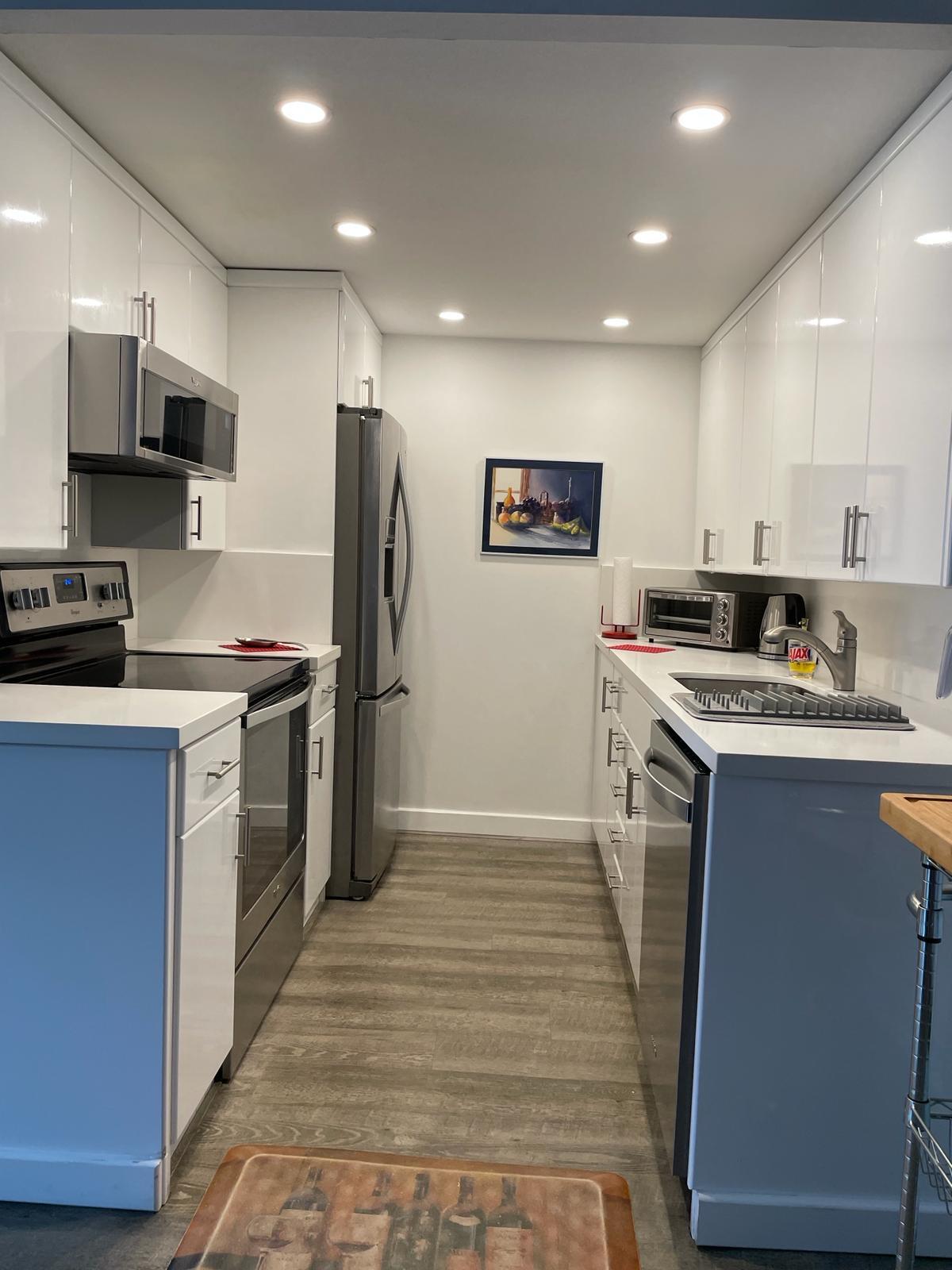 2052 Cornwall C, Unit 2052 Boca Raton, FL 33434 - Photo 11 of 34 a kitchen with stainless steel appliances granite countertop a stove refrigerator sink and microwave