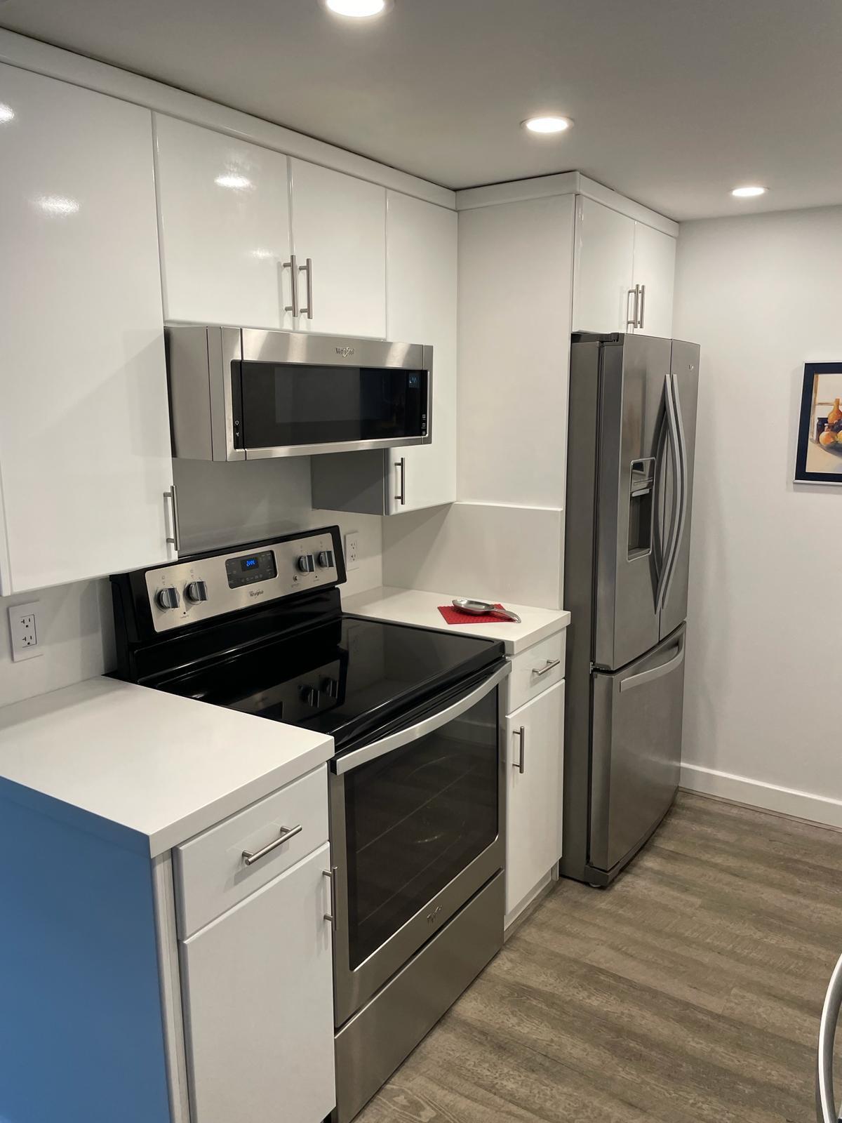 2052 Cornwall C, Unit 2052 Boca Raton, FL 33434 - Photo 12 of 34 a kitchen with stainless steel appliances a refrigerator stove and microwave