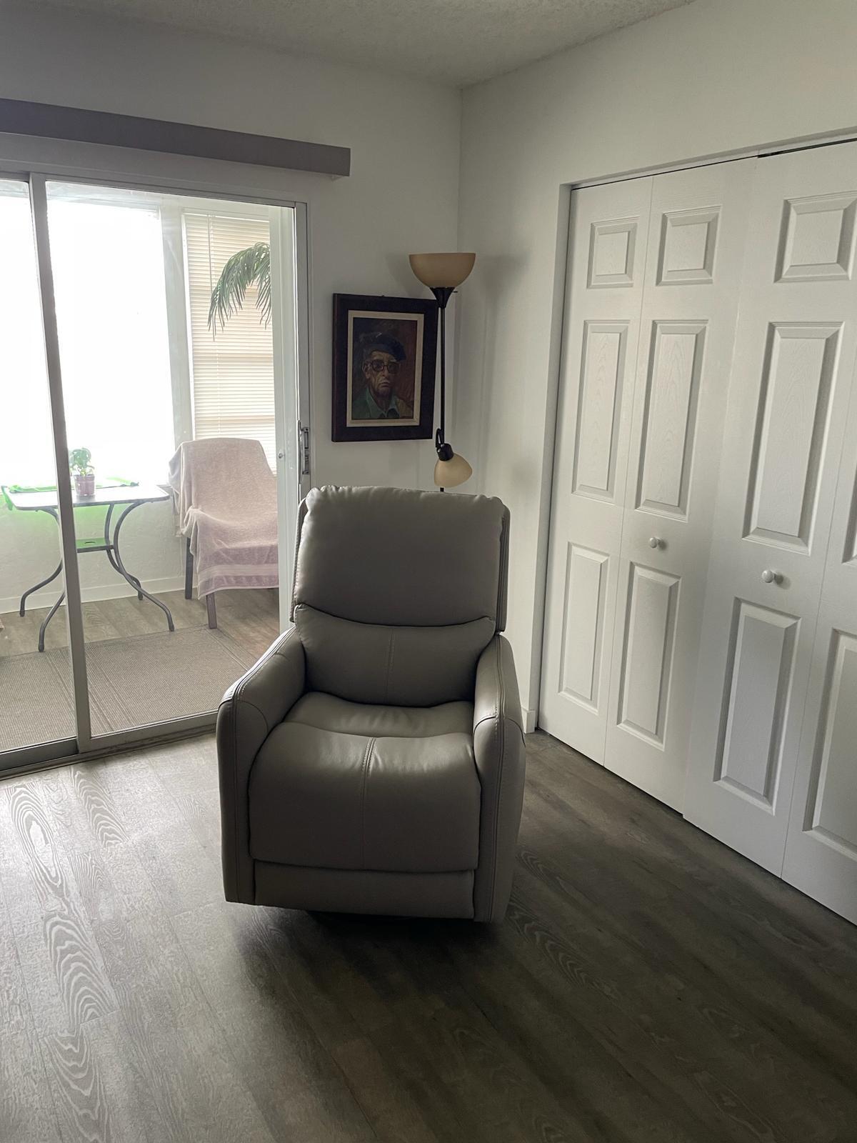 2052 Cornwall C, Unit 2052 Boca Raton, FL 33434 - Photo 22 of 34 a living room with furniture and a flat screen tv