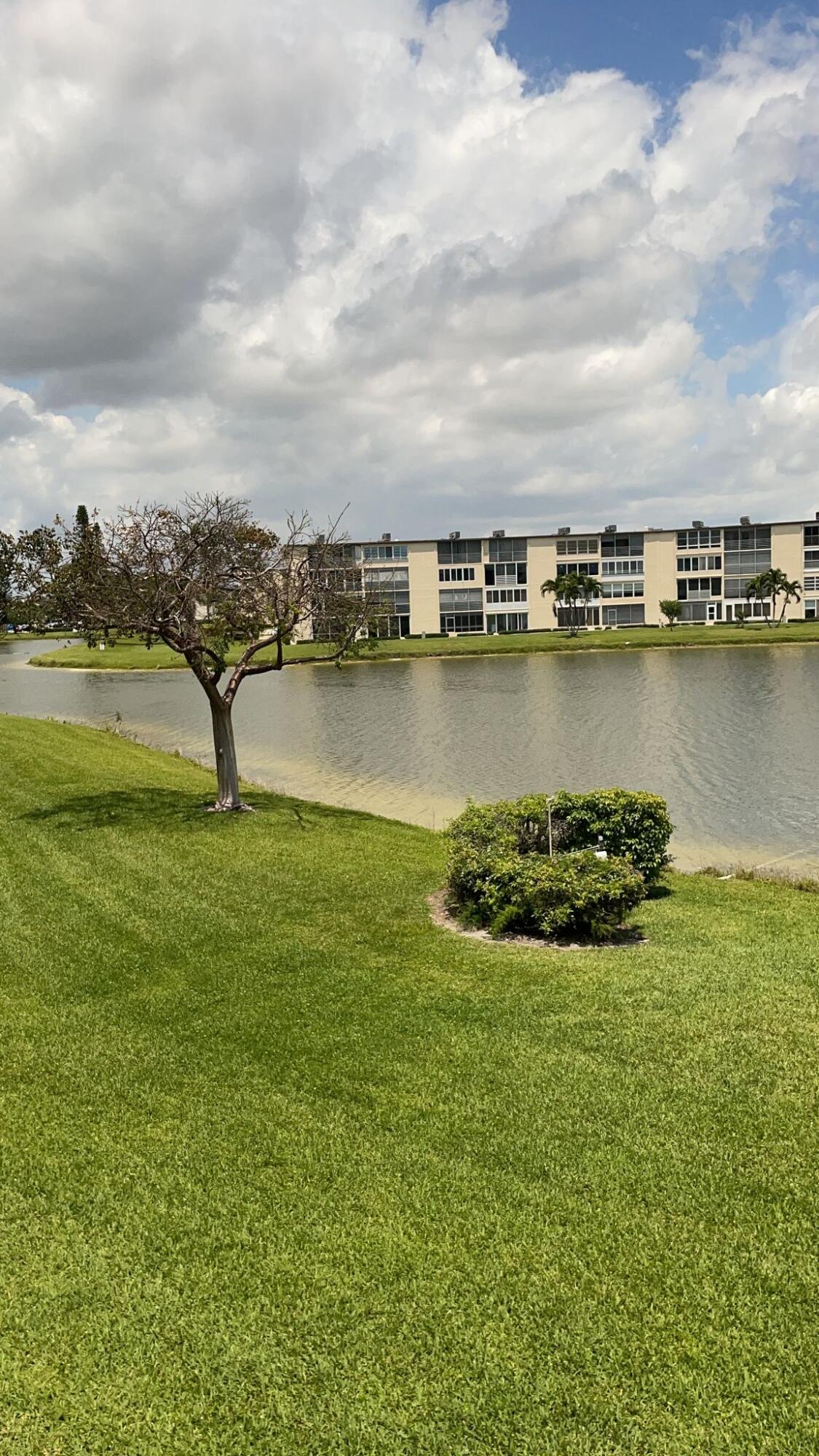 2052 Cornwall C, Unit 2052 Boca Raton, FL 33434 - Photo 23 of 34 a view of a lake with houses