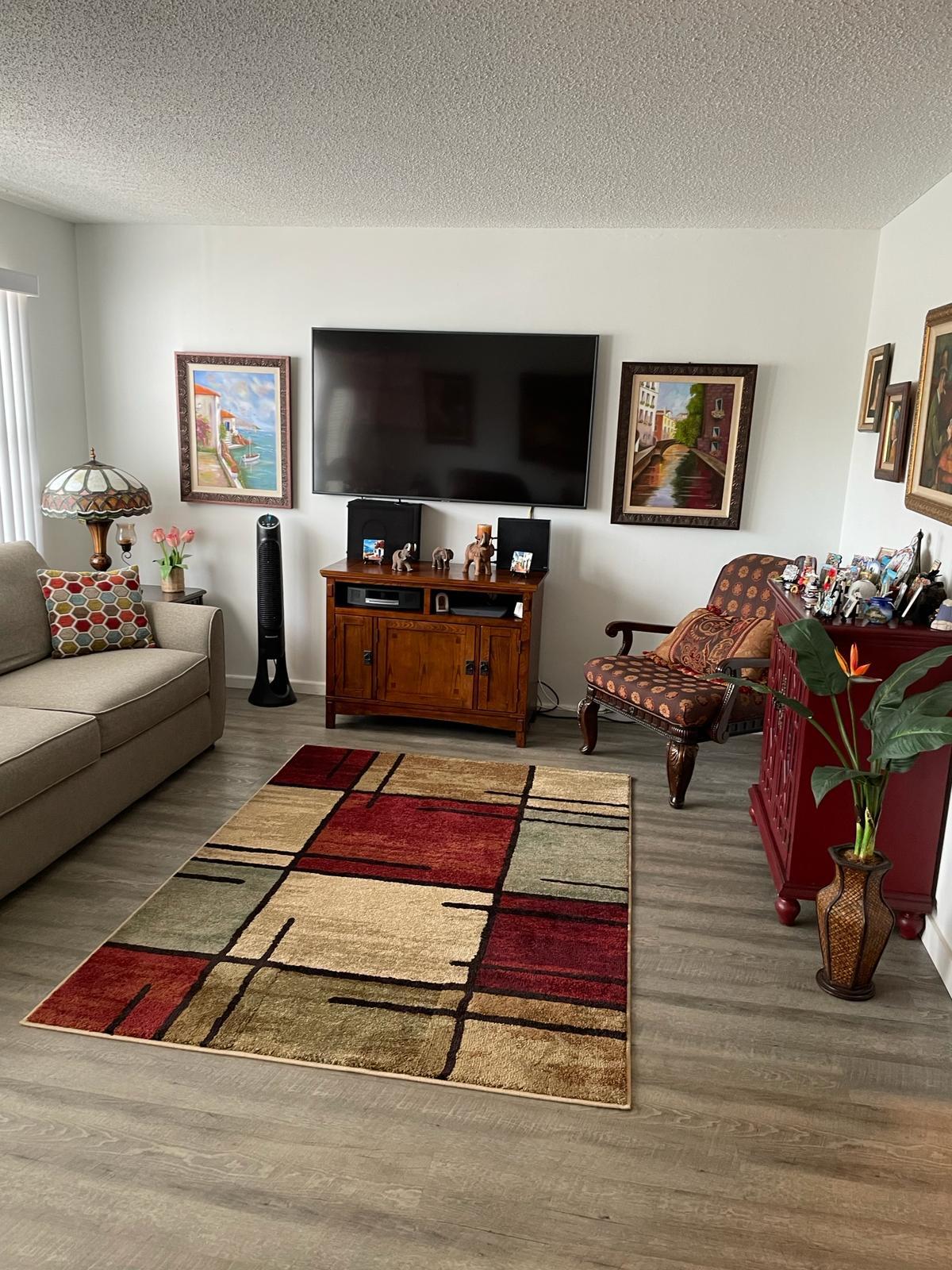 2052 Cornwall C, Unit 2052 Boca Raton, FL 33434 - Photo 5 of 34 a living room with furniture and a flat screen tv