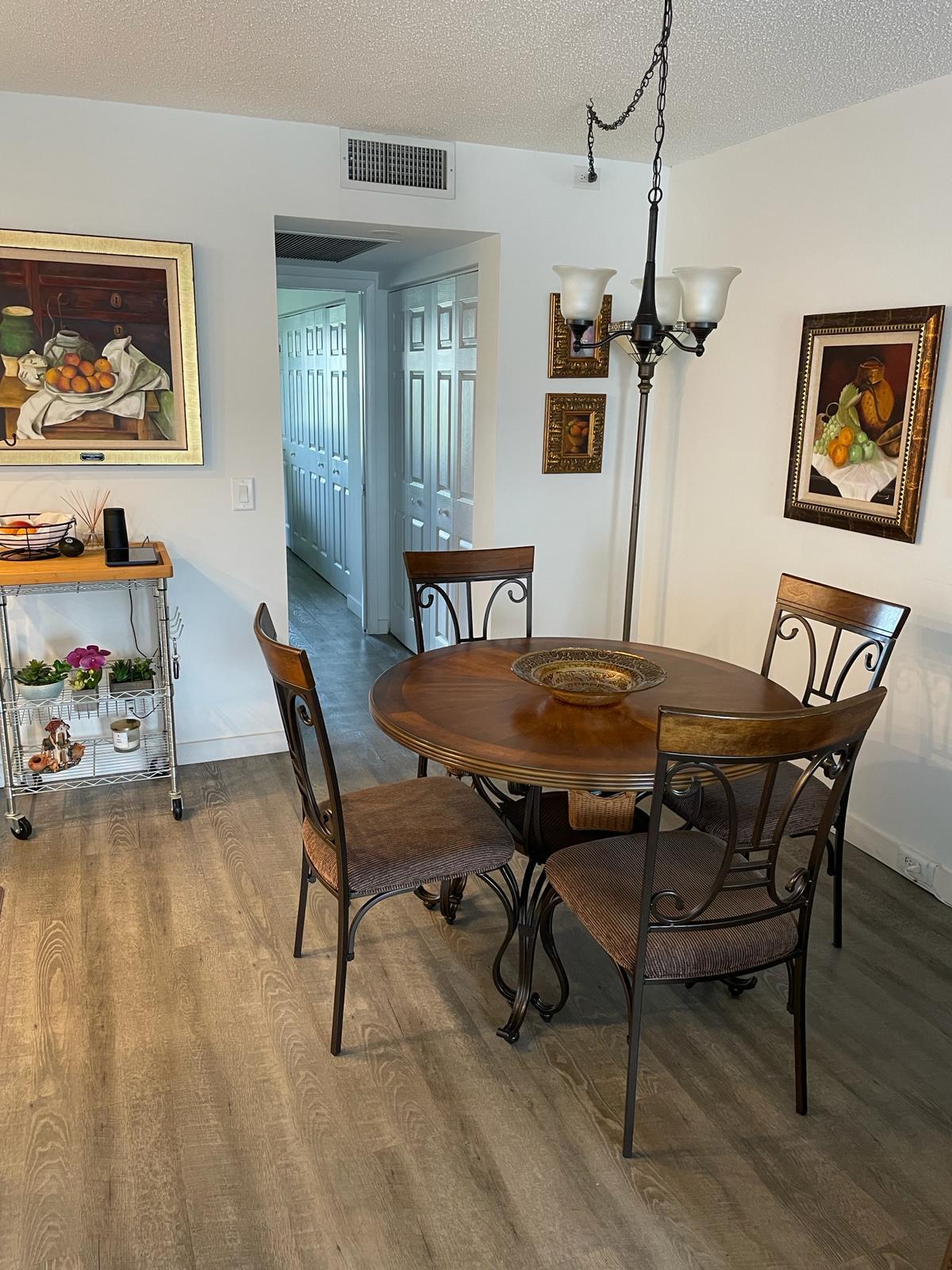 2052 Cornwall C, Unit 2052 Boca Raton, FL 33434 - Photo 10 of 34 a view of a dining room with furniture and wooden floor