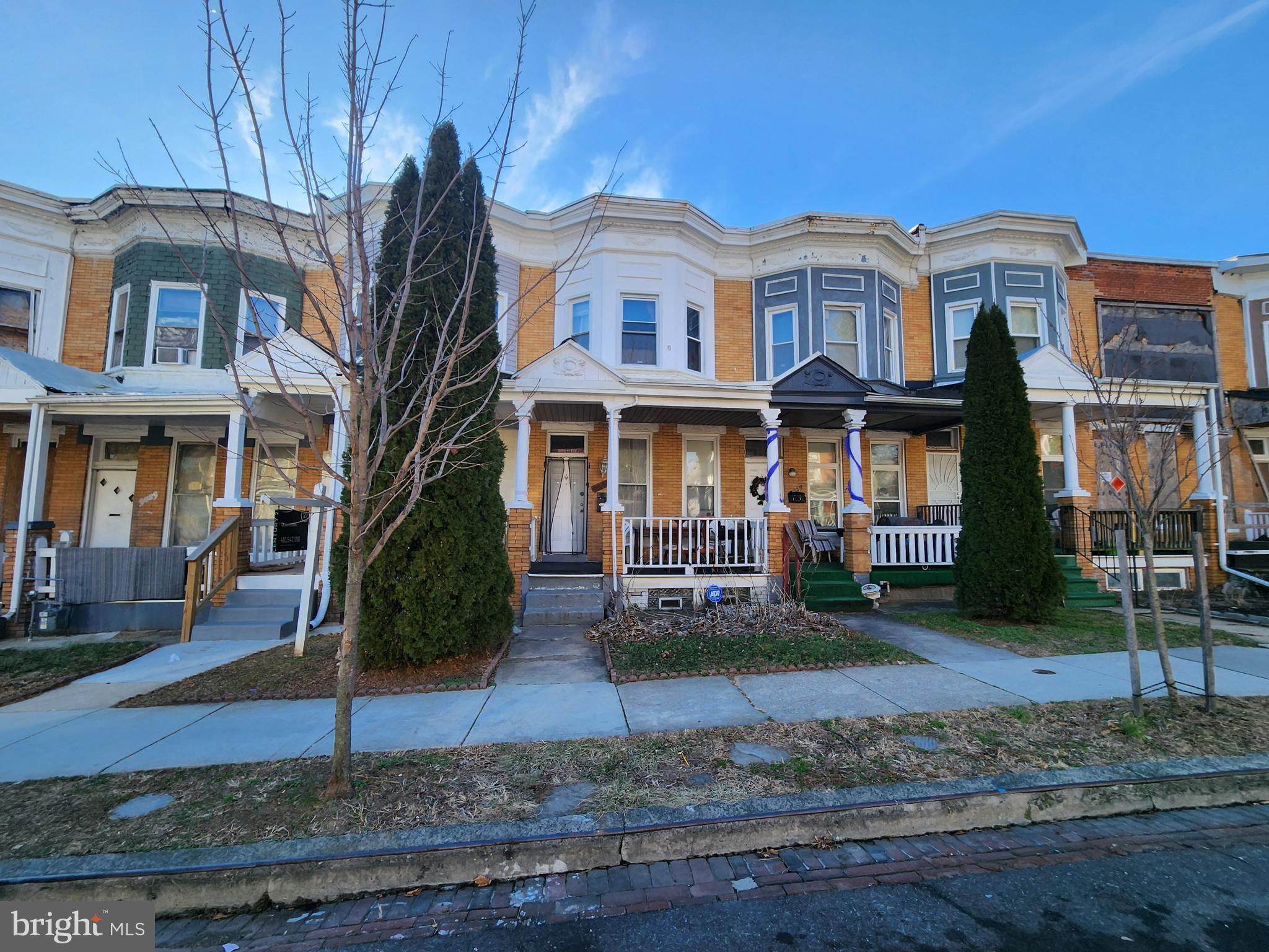 3027 Walbrook Avenue Baltimore, MD 21216 - Photo 1 of 20 a front view of a residential apartment building with a yard