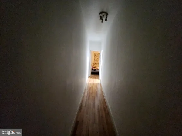 a view of a room with wooden floor