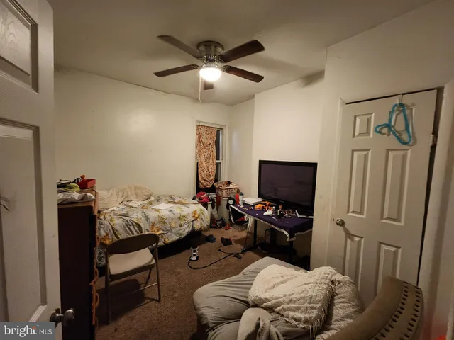 a bed room with furniture and a flat screen tv