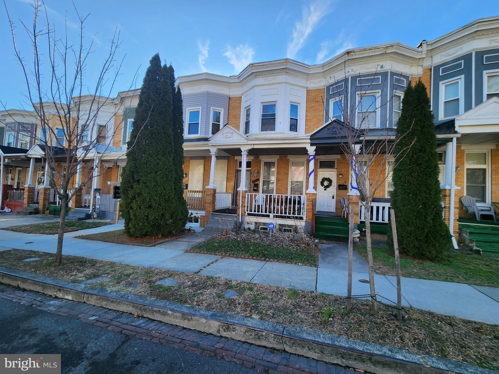 3027 Walbrook Avenue Baltimore, MD 21216 - Photo 2 of 20 a view of a white house with large windows next to a yard