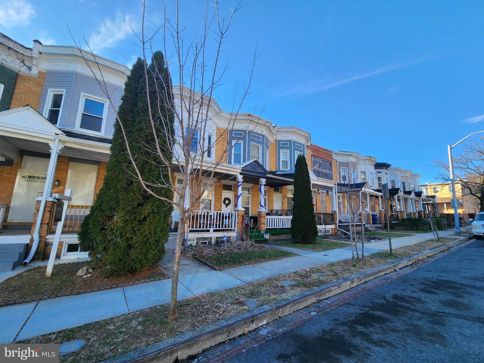 3027 Walbrook Avenue Baltimore, MD 21216 - Photo 3 of 20 a view of a white house with iron fence