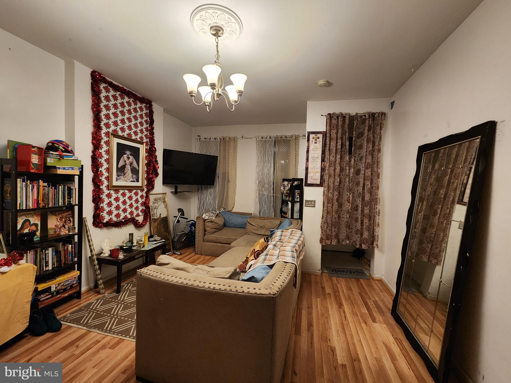 3027 Walbrook Avenue Baltimore, MD 21216 - Photo 6 of 20 a living room with furniture and a flat screen tv