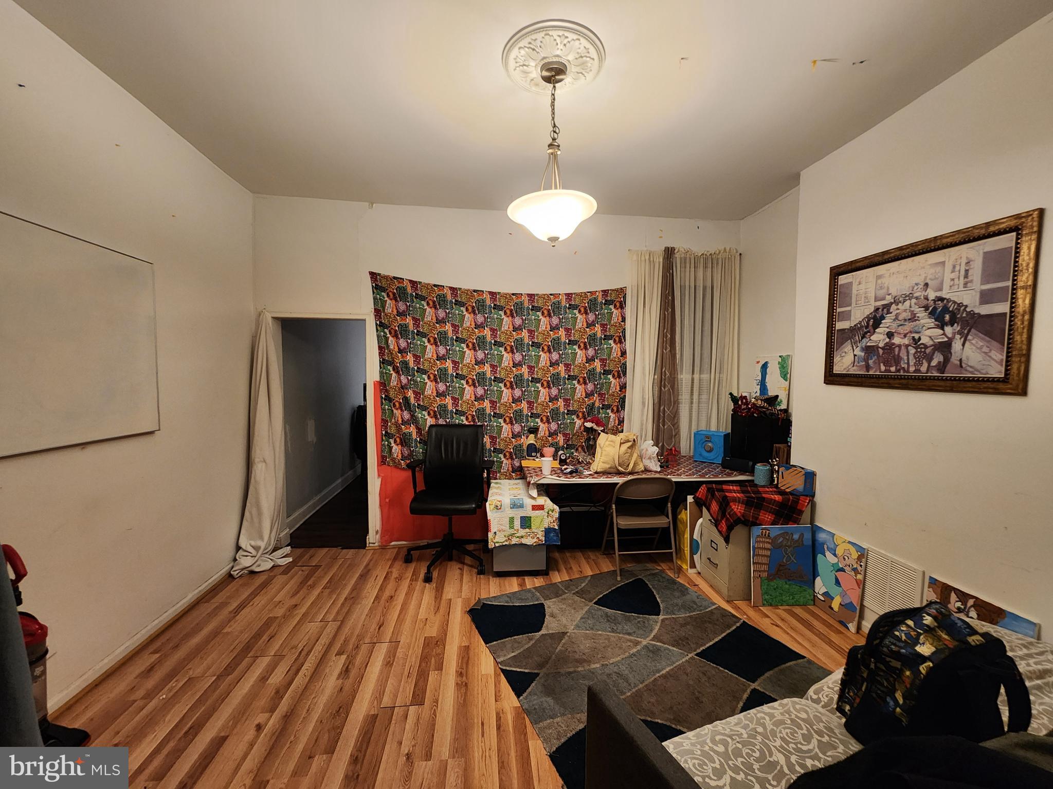 3027 Walbrook Avenue Baltimore, MD 21216 - Photo 8 of 20 a view of a workspace with furniture and chandelier