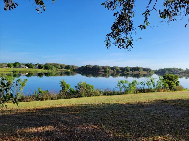 a view of a lake with houses in the back