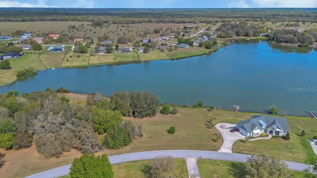 an aerial view of a house with a lake view