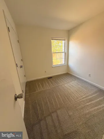 a view of room with window and hardwood floor