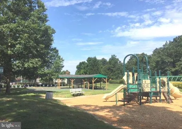 a view of a swimming pool with a bench in the patio