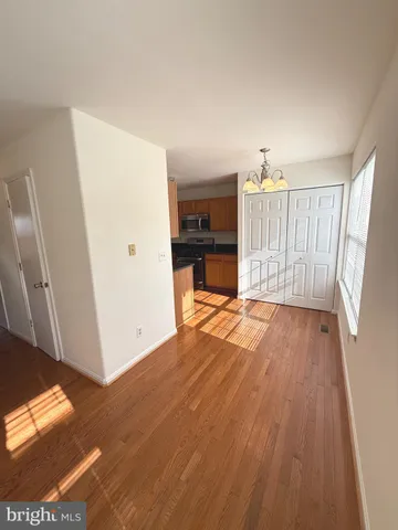 a view of empty room with wooden floor