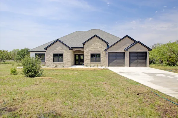 a view of a house with a yard and garage
