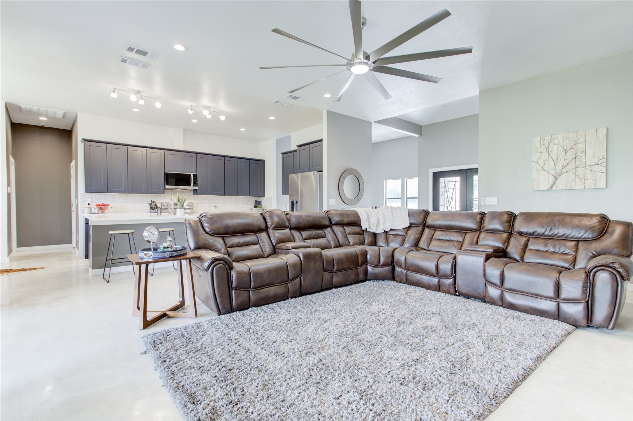 1215 Ridge Harbor Drive Spicewood, TX 78669 - Photo 11 of 39 a living room with furniture and a chandelier