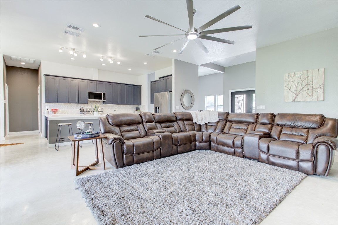 1215 Ridge Harbor Drive Spicewood, TX 78669 - Photo 11 of 39 a living room with furniture and a chandelier