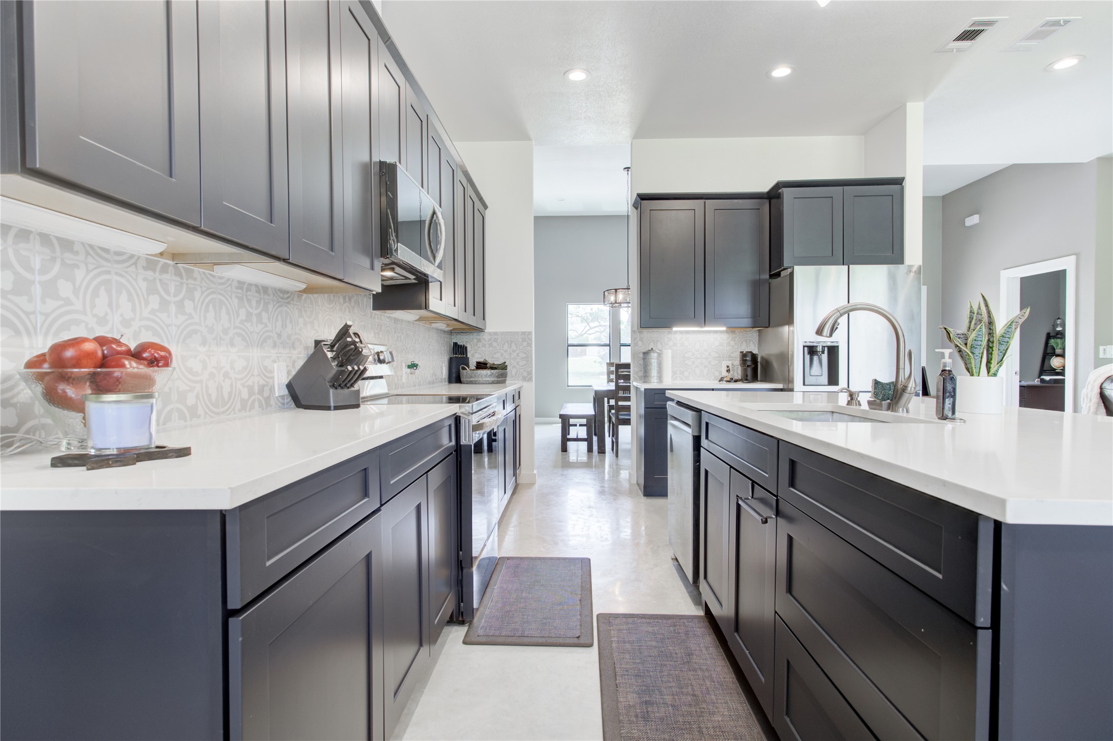 1215 Ridge Harbor Drive Spicewood, TX 78669 - Photo 13 of 39 a kitchen with stainless steel appliances granite countertop a sink a stove and a refrigerator