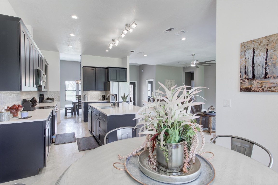 1215 Ridge Harbor Drive Spicewood, TX 78669 - Photo 14 of 39 a living room with furniture a potted plant and a kitchen view