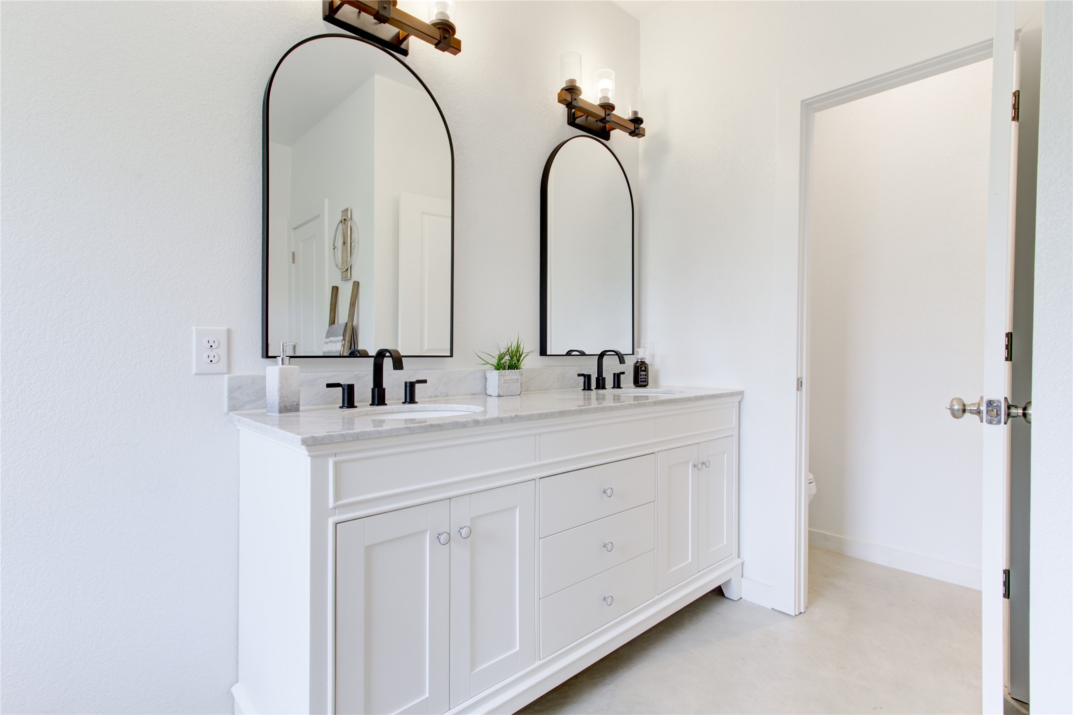 1215 Ridge Harbor Drive Spicewood, TX 78669 - Photo 21 of 39 a bathroom with a double vanity sink and a mirror
