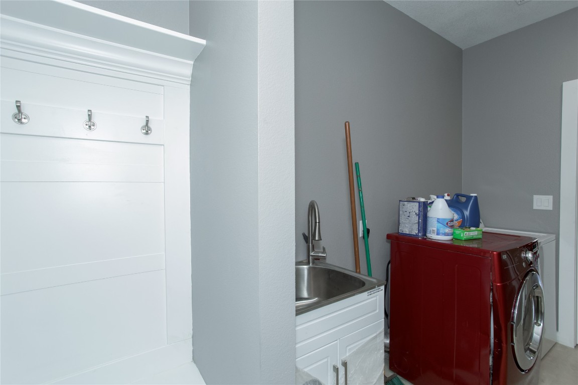 1215 Ridge Harbor Drive Spicewood, TX 78669 - Photo 25 of 39 a utility room with dryer and washer