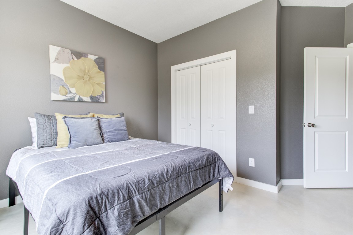 1215 Ridge Harbor Drive Spicewood, TX 78669 - Photo 26 of 39 a bedroom with a bed and a painting on the wall