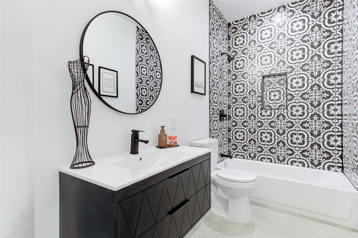 1215 Ridge Harbor Drive Spicewood, TX 78669 - Photo 27 of 39 a bathroom with a sink a toilet and a mirror