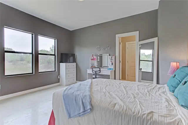 a bedroom with a bed and a table in it