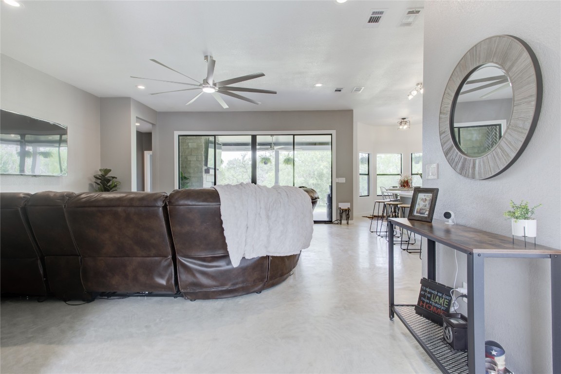 1215 Ridge Harbor Drive Spicewood, TX 78669 - Photo 3 of 39 a living room with furniture a mirror and a large window