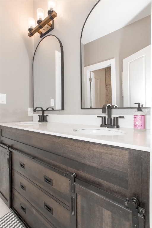 1215 Ridge Harbor Drive Spicewood, TX 78669 - Photo 30 of 39 a bathroom with a double vanity sink and a mirror