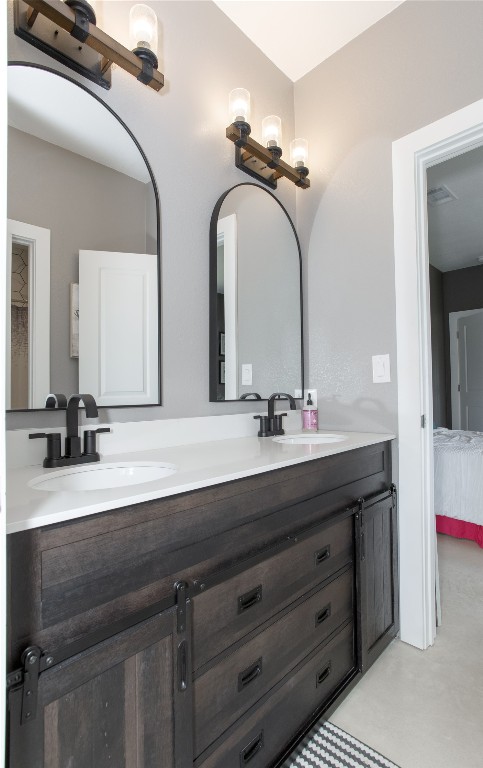 1215 Ridge Harbor Drive Spicewood, TX 78669 - Photo 31 of 39 a bathroom with a double vanity sink and a mirror