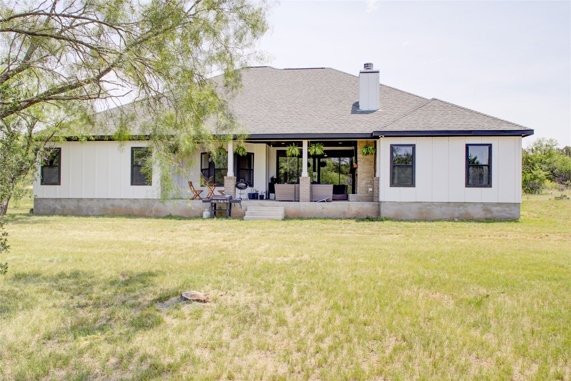 1215 Ridge Harbor Drive Spicewood, TX 78669 - Photo 35 of 39 a front view of house with yard outdoor seating and barbeque oven