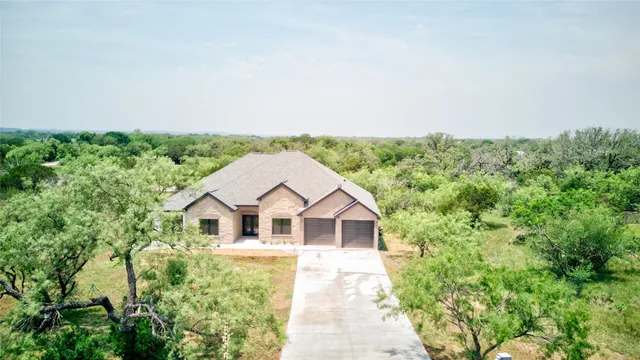 a front view of house with yard outdoor seating and barbeque oven